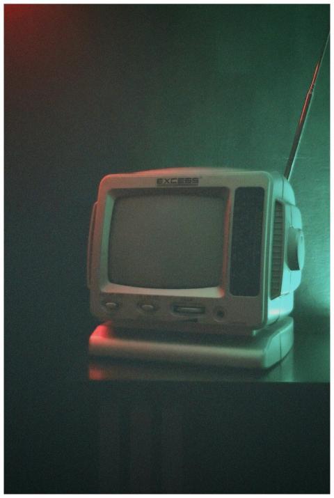 Retro television under moody lighting, evoking nos