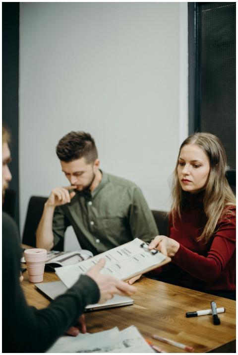 A team of adults discussing documents in an office