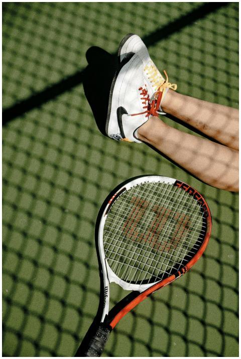 Tennis player in action on an outdoor court with s