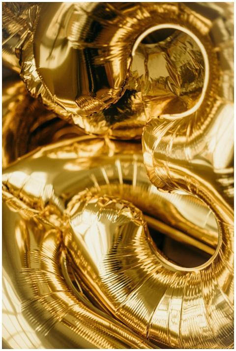 Close-up of metallic gold balloons shaped as numbe