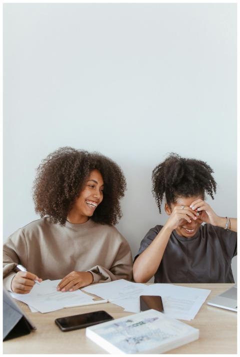 Two teenage girls enjoying a study session at home