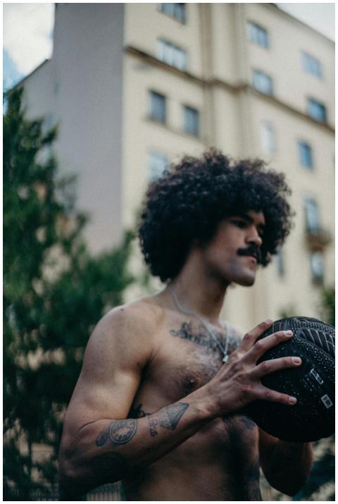 Portrait of a shirtless man with afro and mustache