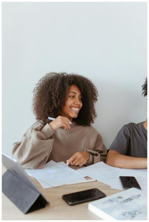 African American woman smiling while studying with