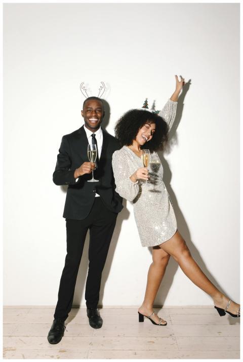 A joyful couple in formal wear celebrating with ch