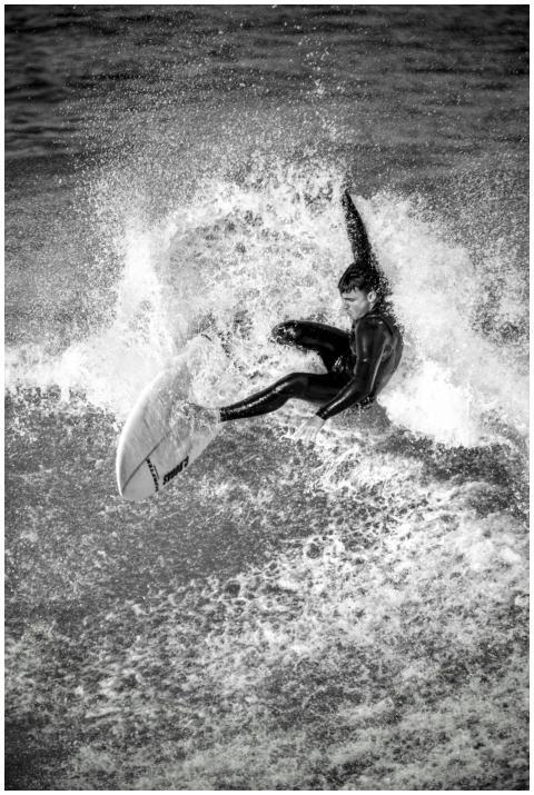 Capturing a surfer in motion with an impactful bla