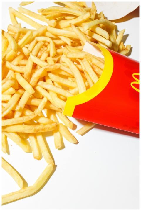 Golden crispy McDonald's fries spilling out of the