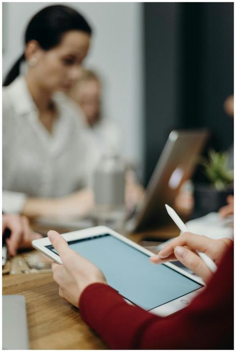 A focused team meeting showcasing digital collabor