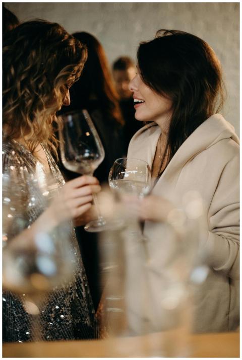 Two women enjoying a spirited conversation over wi