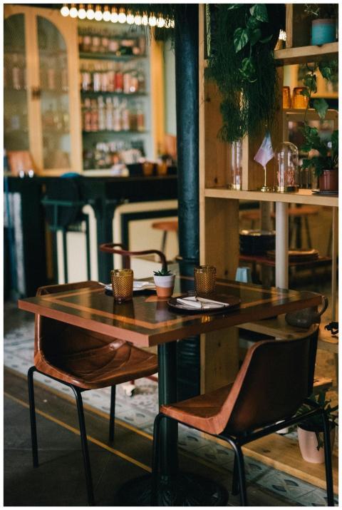 A stylish and modern bar with wooden seating, read