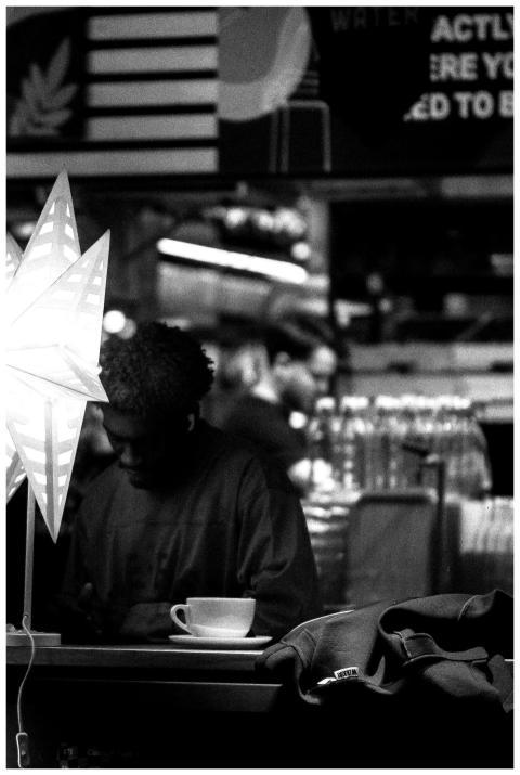 Black and white image of a cafe with a star lamp,