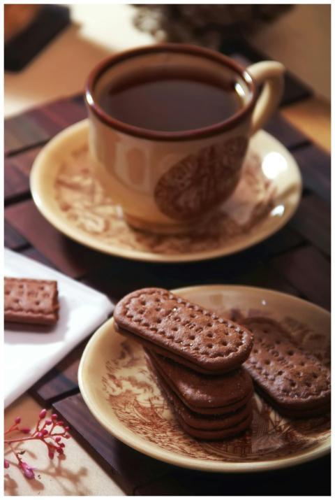 Warm beverage and treats on a saucer, perfect for