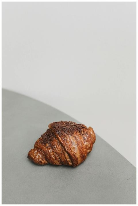 Close-up of a chocolate croissant on a minimalist