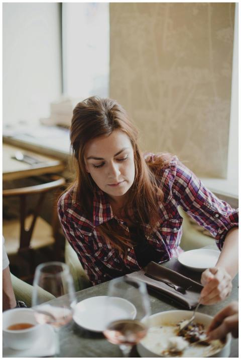 A woman enjoying a meal in a cozy restaurant setti