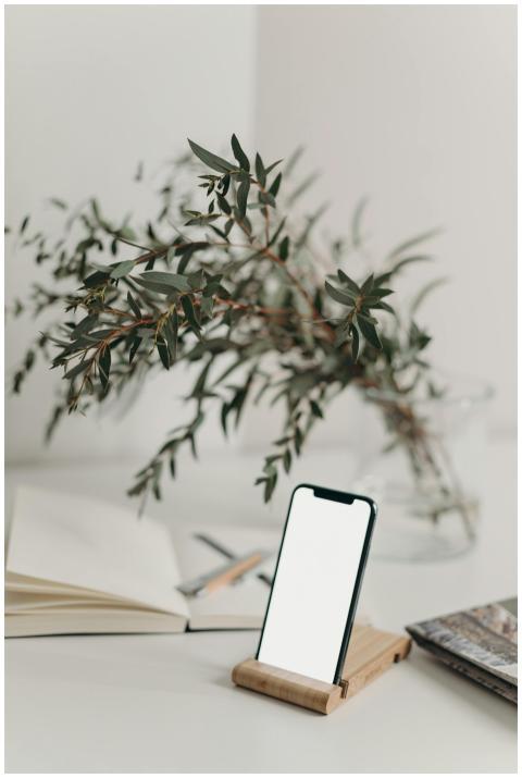 A sleek smartphone with a blank screen on a wooden