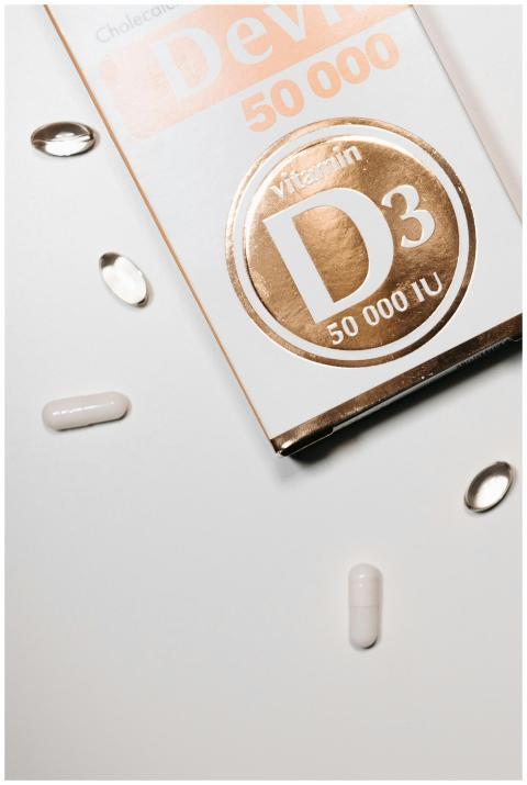 Close-up of vitamin D3 capsules and box on a clean