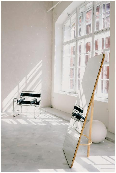 Bright minimalist room with a modern armchair, lar