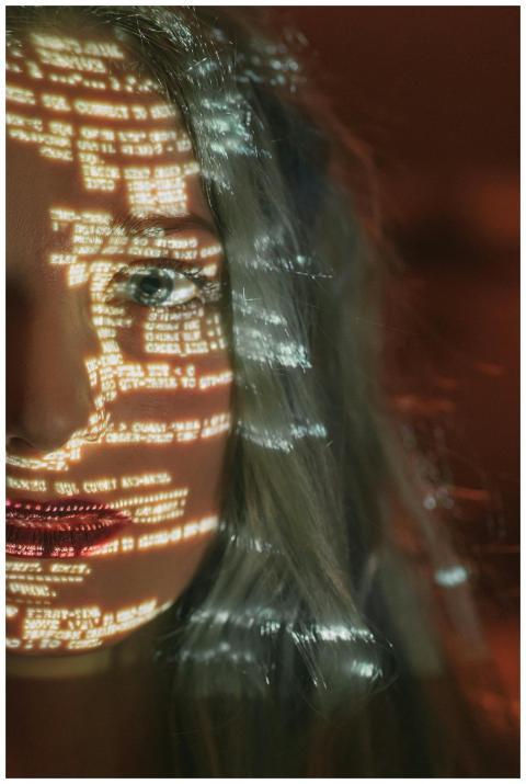 Abstract cyberpunk portrait with code projected on