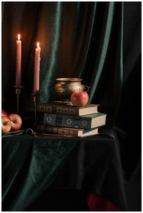 Moody still life with apples, vintage books, and c