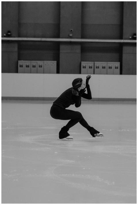 A female figure skater strikes a graceful pose dur