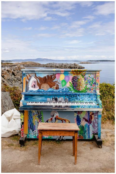 Colorful piano with artistic designs by the seasid