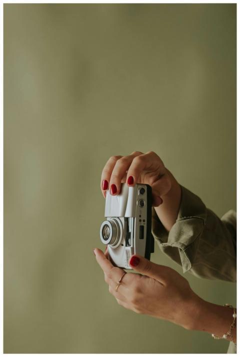Aesthetic close-up of female hands with red nails