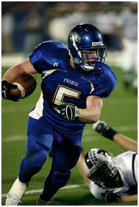 Intense game featuring football player running wit