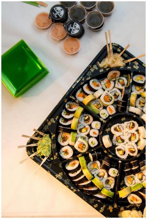 A vibrant sushi platter featuring various rolls wi