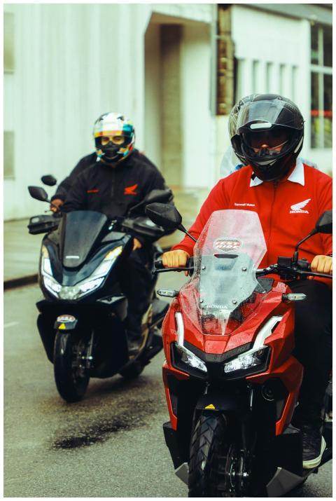 Two motorcyclists on Honda motorcycles navigating