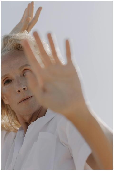 A senior woman poses with grace and style outdoors