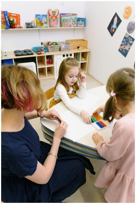 Children in a kindergarten engage in art activitie