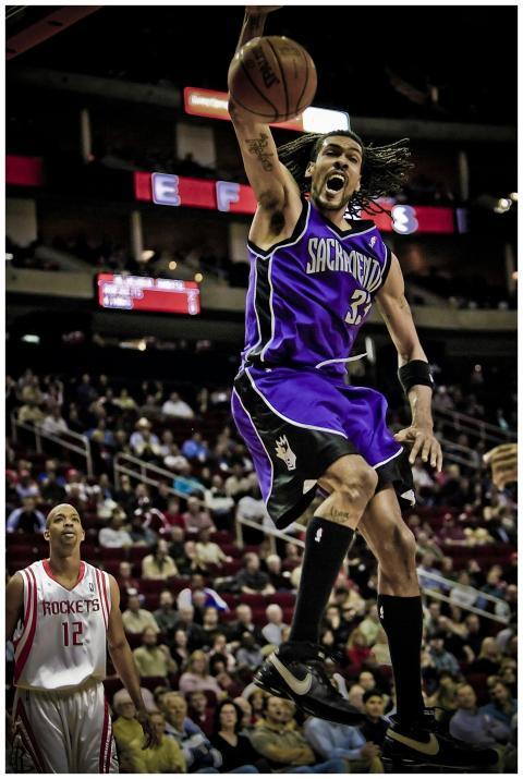 Player making a slam dunk during a basketball game