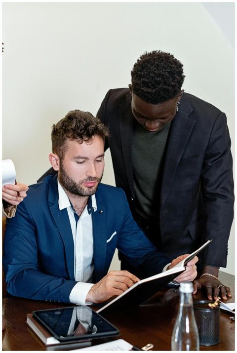 Two businessmen collaborating over a document in a