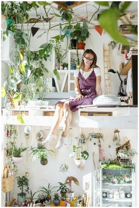 A cheerful woman enjoys leisure time in a lush ind