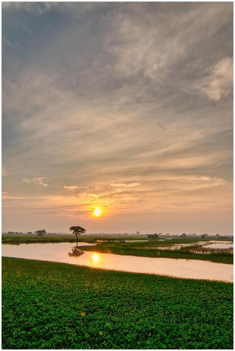 Golden sunset over a serene rural landscape in Ban