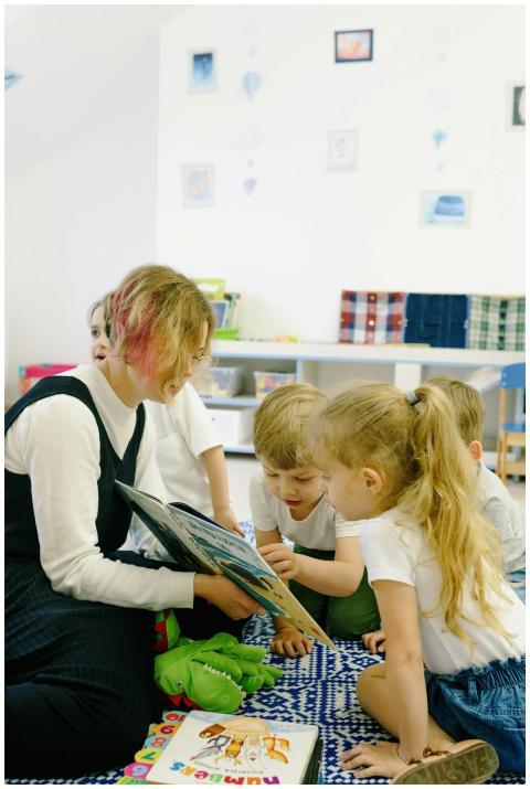 A teacher reading to an attentive group of childre