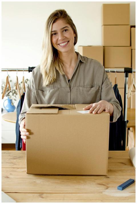 Woman managing online store packaging for small bu