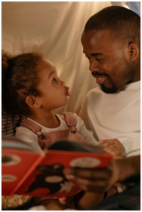 Father and daughter share a bonding moment reading