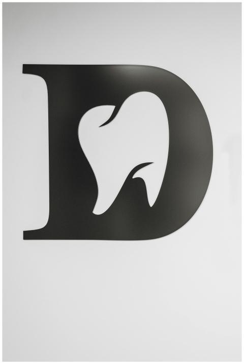 Simple black and white tooth design within letter