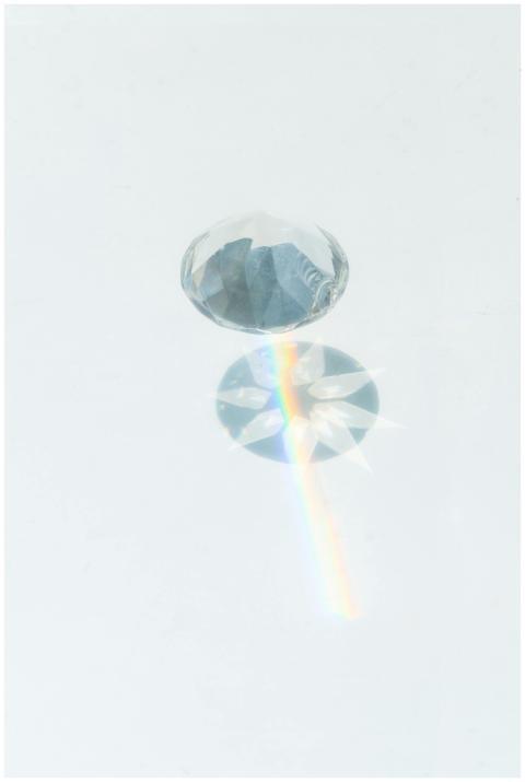 A sparkling diamond casting vibrant rainbow reflec