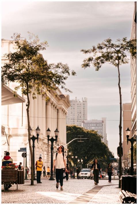 People walk along a scenic street in Curitiba, Bra