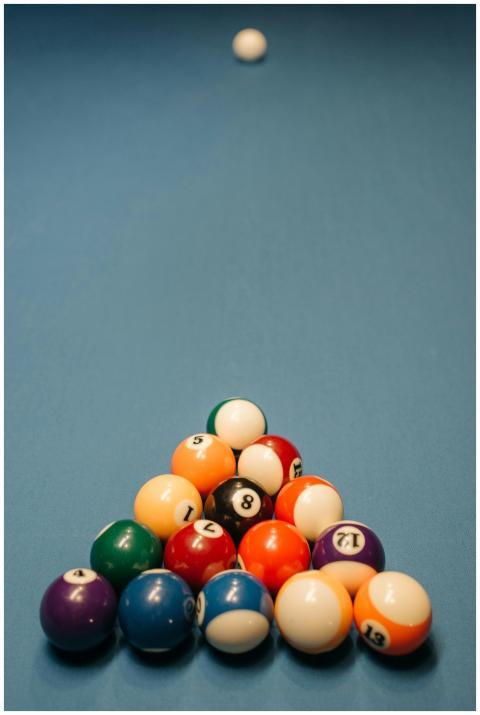 Colorful pool balls arranged on a billiard table w