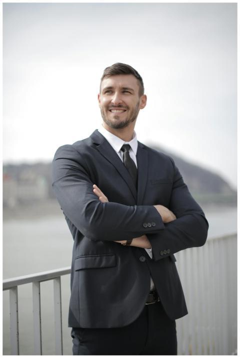Smiling businessman in a suit standing confidently
