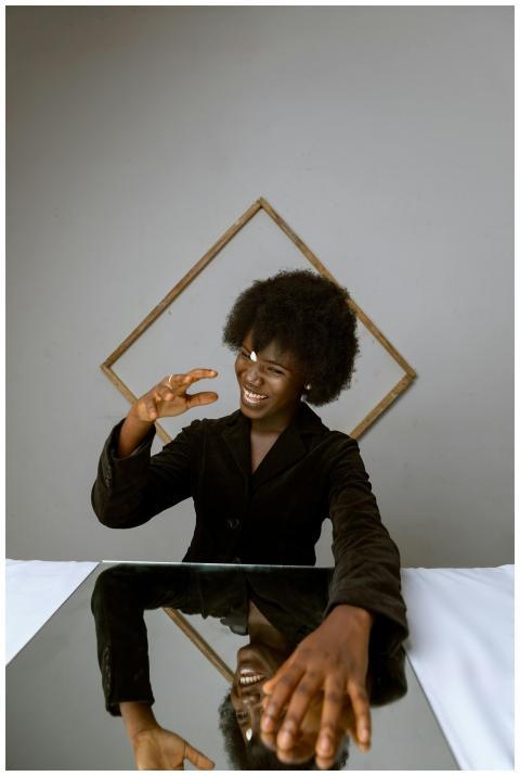 African American woman in black blazer smiling and