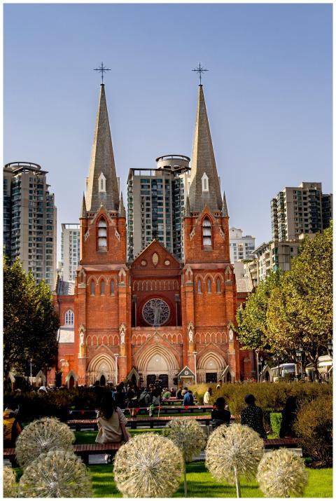 Beautiful red brick cathedral nestled among urban