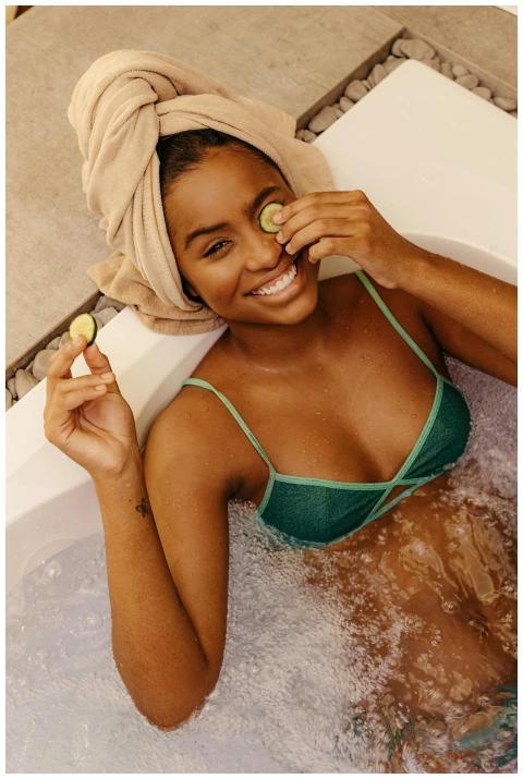 Woman enjoying a spa day with cucumber eye mask, s