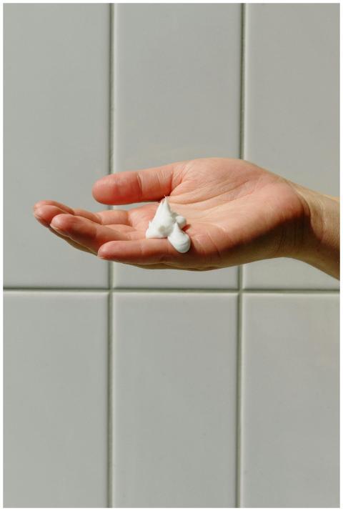 Close-up of a hand with cream, emphasizing skincar