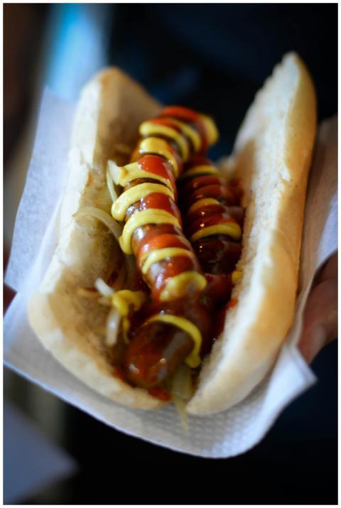 Close-up of a hot dog with ketchup, mustard, and o