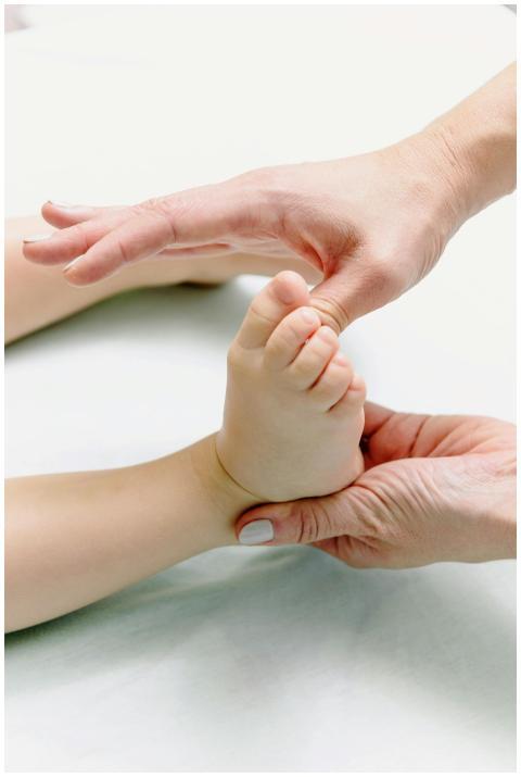 Tender close-up capturing hands massaging a baby's