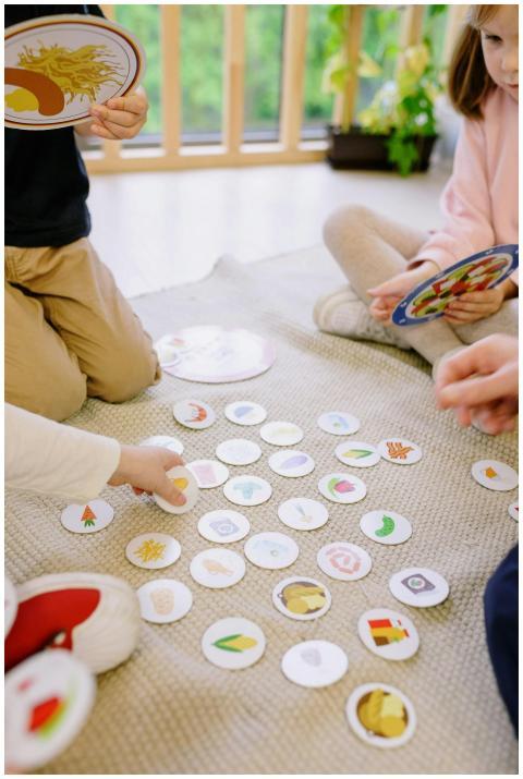 Three children engage in a fun card game while sea