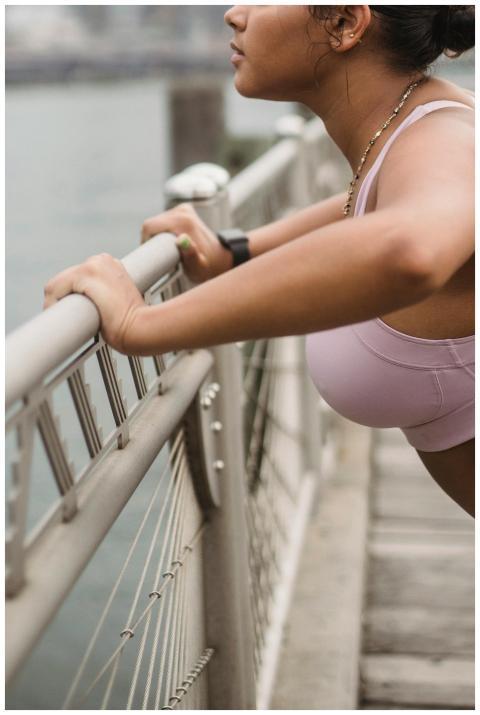 Side view of a woman in pink sportswear performing